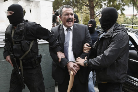 Extreme-right Golden Dawn party senior lawmaker Christos Pappas is escorted by anti-terrorism police officers to a courthouse in Athens
