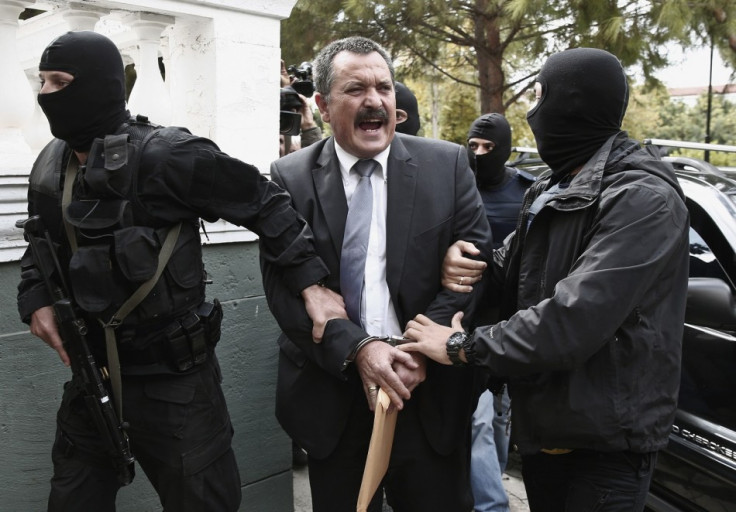Extreme-right Golden Dawn party senior lawmaker Christos Pappas is escorted by anti-terrorism police officers to a courthouse in Athens