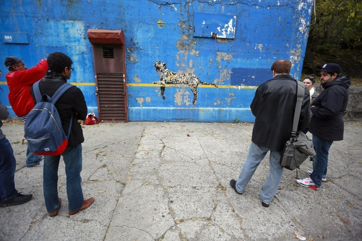 Spectators gather to check out Bronx Zoo by Banksy near the New York Yankees stadium PIC: Reuters