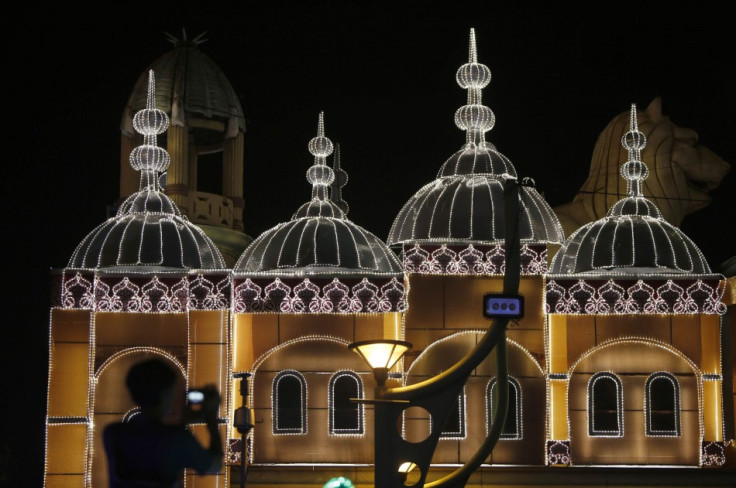 A man takes pictures of light decorations before upcoming Diwali celebrations in Kuala Lumpur