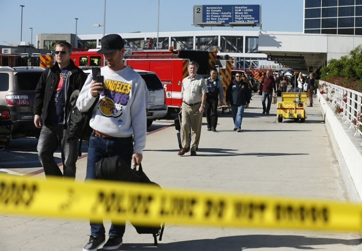 Passengers evacuate after a shooting incident at Los Angeles airport (Picture: Reuters)