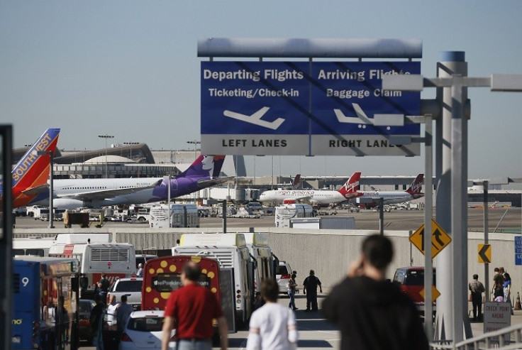 Traffic comes to a standstill as buses evacuate passengers from terminal 3 on the tarmac after a shooting at Los Angeles airport (Picture: Reuters)
