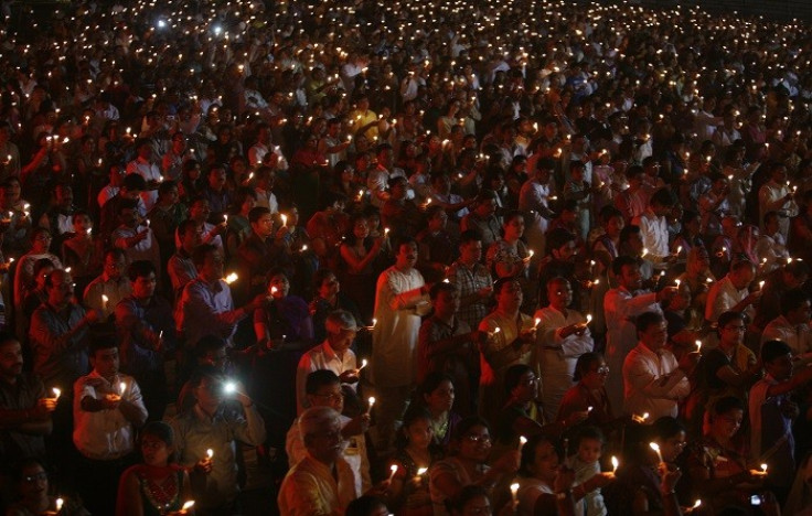 People hold candles during a mass gathering to celebrate Diwali, the Hindu festival of lights, in the western Indian city of Ahmedabad November 13, 2012. REUTERS/Amit Dave (INDIA - Tags: RELIGION SOCIETY)