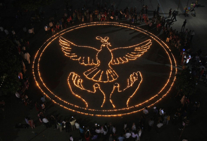 People light lamps as they make a formation of a peace symbol on the eve of Diwali in Chandigarh, India. (Photo: Reuters)
