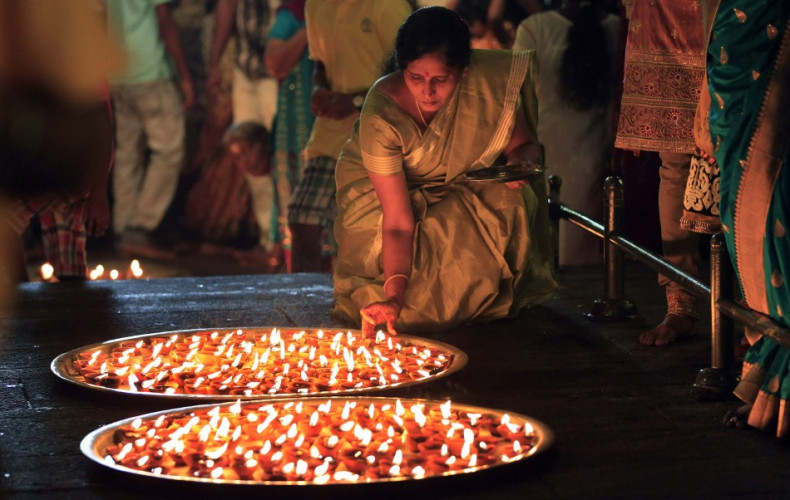 A devotee lights oil lamps during Diwali at a Hindu temple in Colombo. Lighting diyas is the vital tradition of Diwali. (Photo: Reuters)