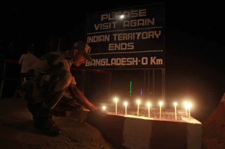 A BSF soldier lights a candle on the occasion of the Hindu festival of Diwali at the India-Bangladesh border on the outskirts of Agartala. (Photo: Reuters)