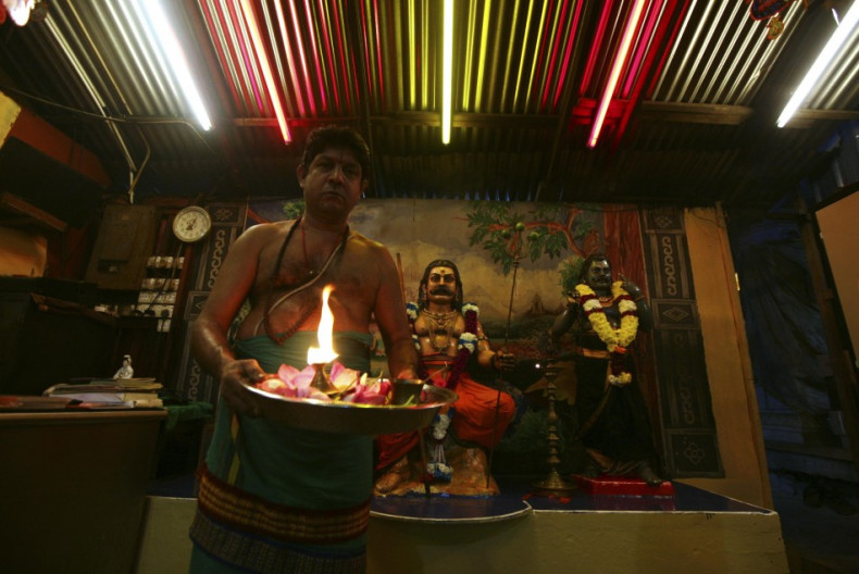 A Hindu priest holds an oil lamp after Diwali prayers inside a Hindu temple in Kuala Lumpur. (Photo: Reuters)