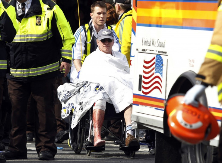 Alicia Ann Lynch, dressed up as a Boston Marathon bombing victim, to her office Halloween party. Here, a runner in a wheelchair is taken from a triage tent after explosions went off at the 117th Boston Marathon in Boston, Massachusetts April 15, 2013. (Re