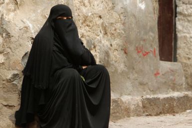 A woman sits in an alley in the Old City of Ibb, the provincial capital of Yemen's central province of Ibb. Yemen is the most unfair country for women, a new report suggests. (Photo: REUTERS)