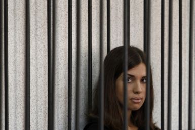 Member of the female punk band "Pussy Riot" Nadezhda Tolokonnikova looks out from a holding cell as she attends a court hearing to appeal for parole at the Supreme Court of Mordovia