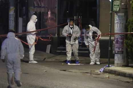 Police forensic experts search for evidence outside the local offices of far-right Golden Dawn party,