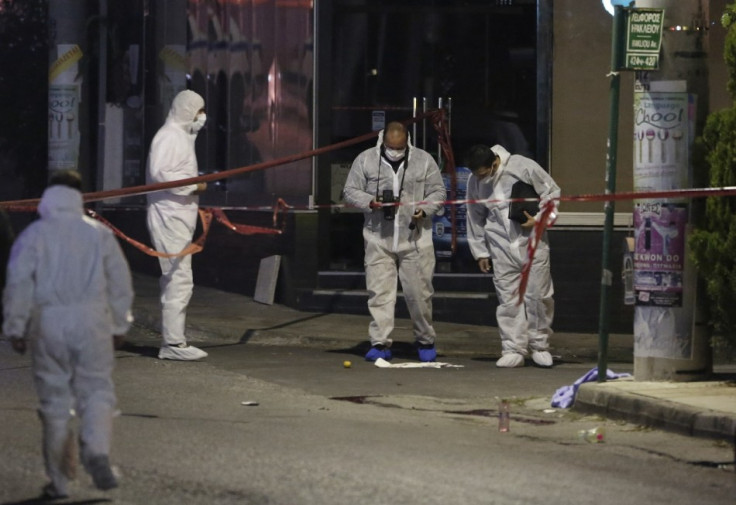 Police forensic experts search for evidence outside the local offices of far-right Golden Dawn party,