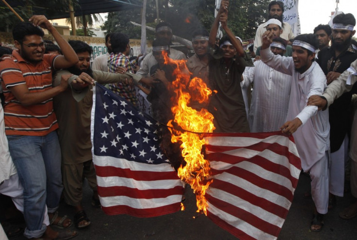 Supporters of the Jamaat-ud-Dawa Islamic organization burn the U.S. flag