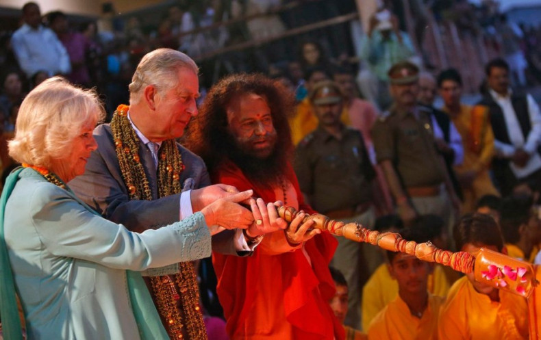 Prince Charles and his wife Camilla, Duchess of Cornwall, perform a ritual as part of an Aarti ceremony at Parmarth Miketan Temple on banks of river Ganges in Rishikesh. (Photo: Reuters)