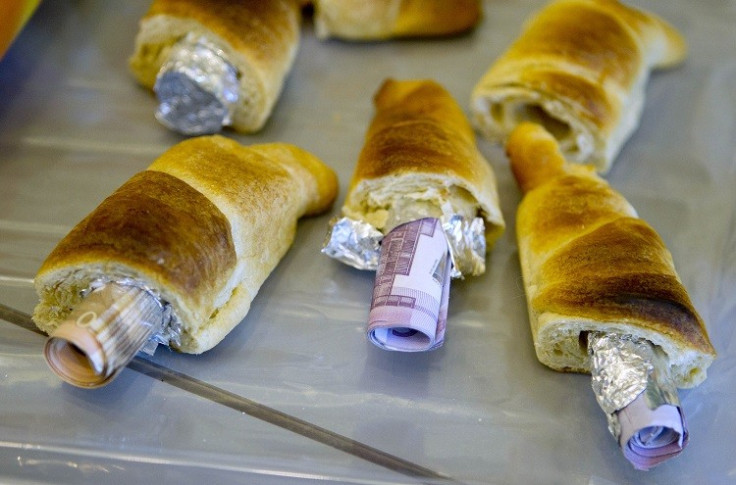 Money concealed in pastries that the German customs agency Zoll seized during an anti-money laundering operation, is displayed before the agency's annual statistics news conference at the finance ministry in Berlin March 16, 2012 (Photo: Reuters)