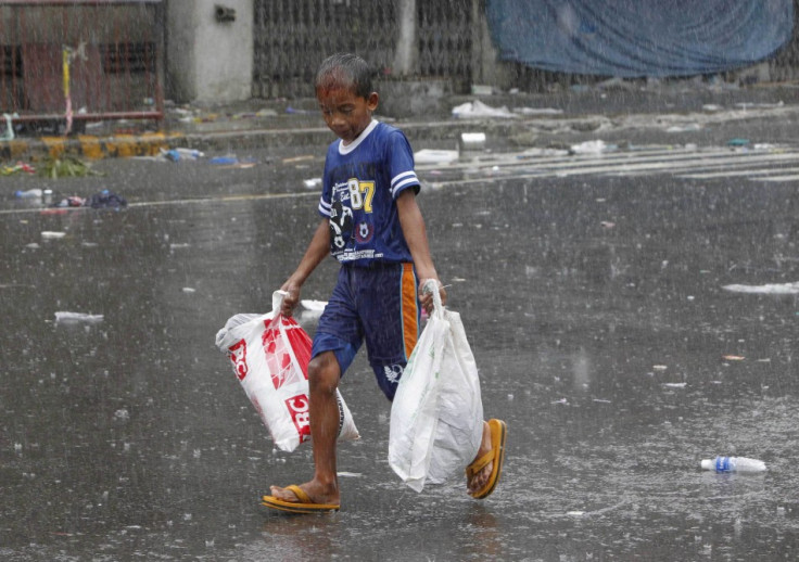 A boy carries relief goods after super Typhoon Haiyan battered Tacloban city