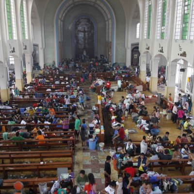 People take refuge in a Catholic church converted to a disaster relief centre in Tacloban City.