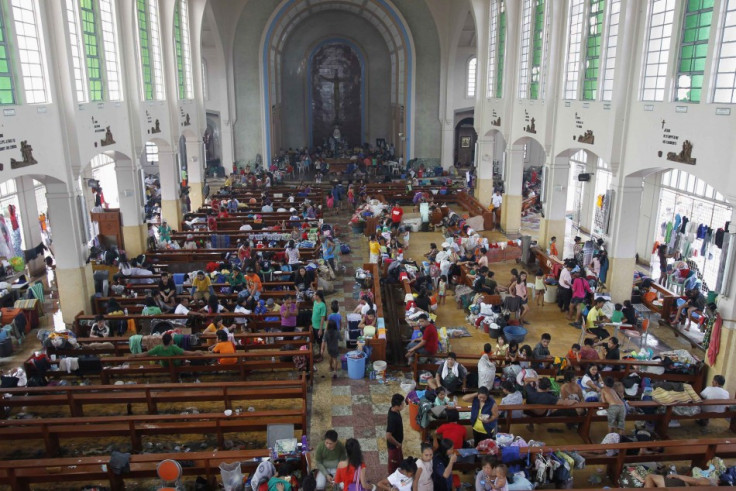 People take refuge in a Catholic church converted to a disaster relief centre in Tacloban City.