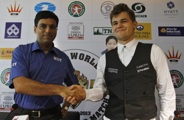India's Viswanathan Anand (L) shakes hands with Norway's Magnus Carlsen during their joint news conference ahead of the FIDE World Chess Championship in the southern Indian city of Chennai November 7, 2013.