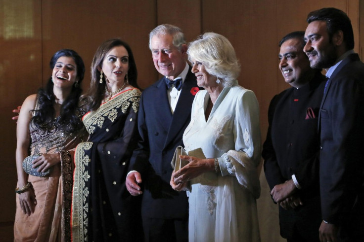 Britain's Prince Charles and his wife Camilla, stand with Nita Ambani, Kajol, Mukesh Ambani and Ajay Devgan before a dinner to support the work of British Asian Trust in Mumbai