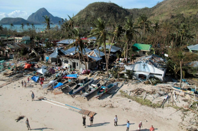 An aerial view shows damaged houses, as residents wave for help after Typhoon Haiyan hit a village in Panay island, in northern Iloilo Province. (Photo: REUTERS/Erik De Castro) An aerial view shows damaged houses, as residents wave for help after Typhoon Haiyan hit a village in Panay island, in northern Iloilo Province. (Photo: REUTERS/Erik De Castro)