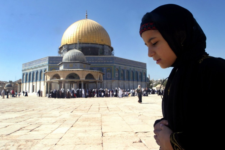 Palestinian girl prays during holy month of Ramadan in front of the Dome of the Rock mosque in Al-Aqsa mosque compound