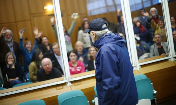 supporters wave to defendant Christian Gauger (front) as he arrives for the start of his trial on charges related to arson and bombing attacks in the late 1970s