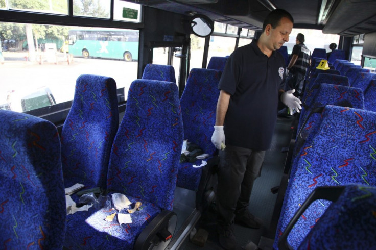 An Israeli policeman surveys the scene of a stabbing incident on a bus in the northern Israeli town of Afula