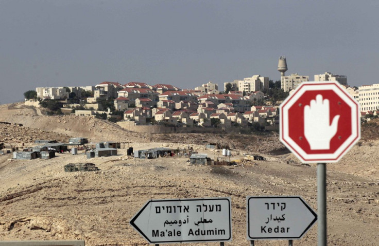Sign posts are seen in front of the West Bank Jewish settlement of Maale Adumim