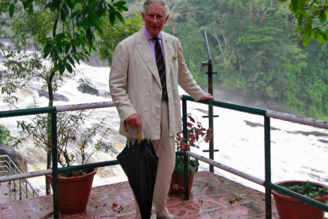 Prince Charles poses for pictures against the backdrop of Vazhachal waterfalls at Thrissur district in Kerala. The prince of Wales turned 65 on 14 November. (Photo: Reuters)