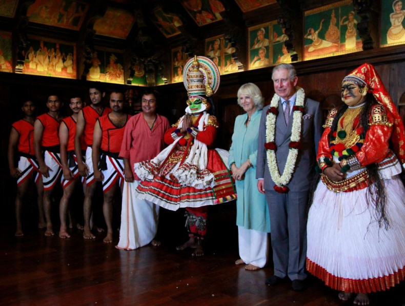 Prince Charles and Camilla pose with artists after watching their performance at the Kerala Folklore Museum and Theatre in Kochi. (Photo: Reuters)