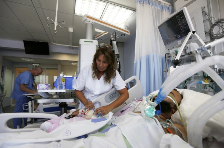 An Israeli nurse treats a badly wounded Syrian fighter PIC: Reuters