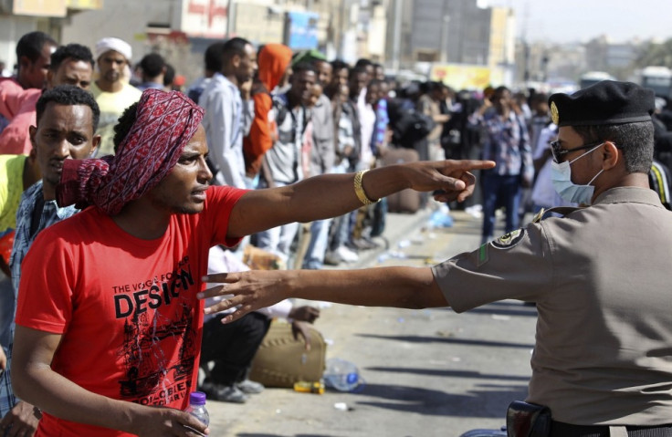 An Ethiopian worker argues with a member of the Saudi security forces as he waits with his countrymen to be repatriated in Manfouha, southern Riyadh