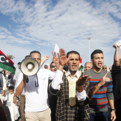 Protesters march during a demonstration calling on militiamen to leave, in Tripoli