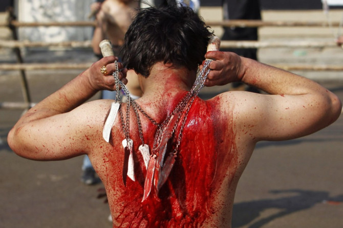 An Afghan Shi'ite Muslim flagellates himself during an Ashura procession in Kabul November 14, 2013.