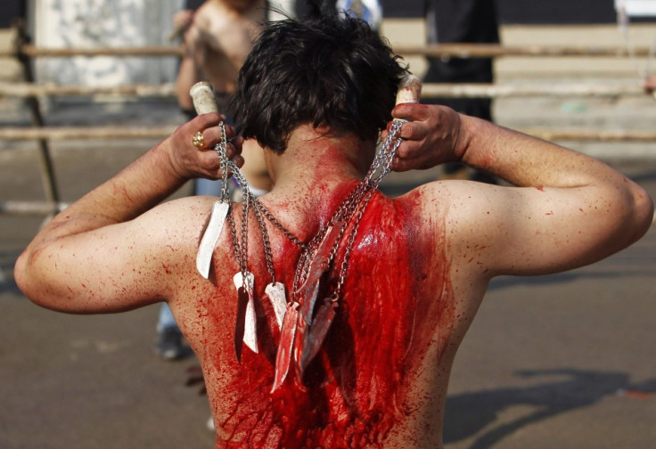 An Afghan Shi'ite Muslim flagellates himself during an Ashura procession in Kabul November 14, 2013.