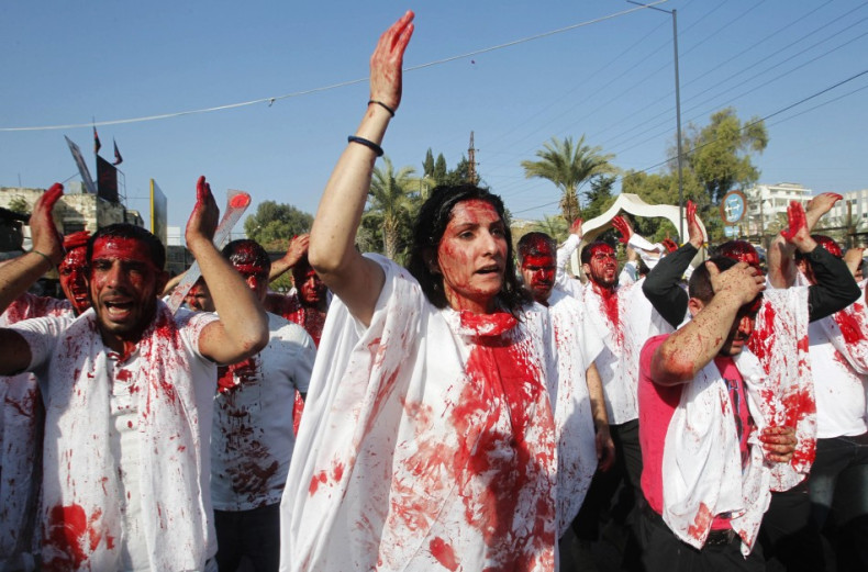 A Shi'ite Muslim woman marches with men, who are bleeding after tapping their foreheads with razors, during a Muharram procession. (Photo: REUTERS/Ali Hashisho)