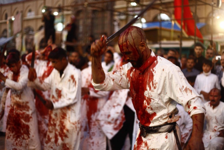 Iraq Shi'ite Muslim men bleed as they gash their foreheads with swords and beat themselves during the religious festival of Ashura in Najaf, 160km (100 miles) south of Baghdad. (Photo: REUTERS/Alaa Al-Marjani)