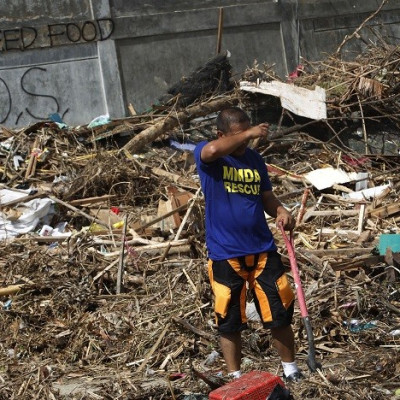 Rescue worker searches for missing typhoon victims, which include 61-year-old Colin Bembridge and his young family. (Reuters)