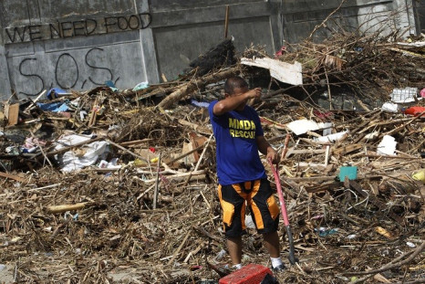 Rescue worker searches for missing typhoon victims, which include 61-year-old Colin Bembridge and his young family. (Reuters)