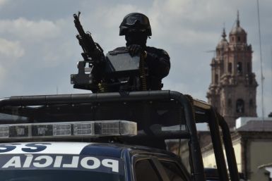 Federal police officers patrol the streets of Morelia, Michoacan.