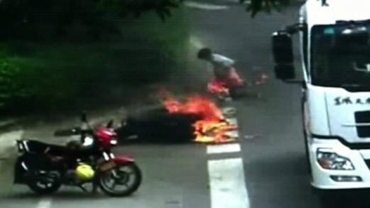 The motorcyclist catches fire after the accident in Foshan City, China.