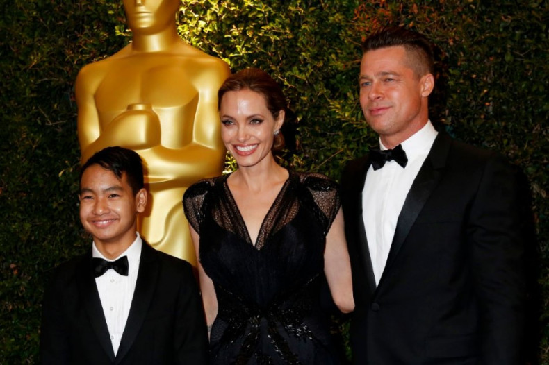 Angelina Jolie and partner Brad Pitt and son Maddox arrive at the fifth Annual Academy of Motion Picture Arts and Sciences Governors Awards in Hollywood November 16, 2013.  (Reuters)