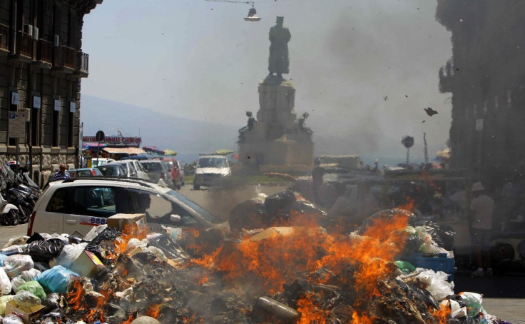 A car is torched during a protest in Naples in July, 2011.