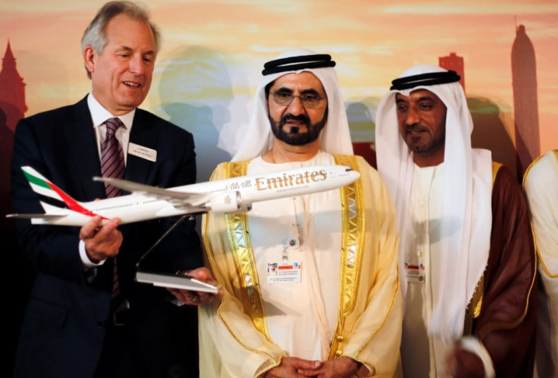 Boeing Chairman James McNerney (L) shows United Arab Emirates' Prime Minister and Ruler of Dubai Sheikh Mohammed bin Rashid al-Maktoum (2nd R) a model of the new version of its 777 long-haul jet during the Dubai Airshow (Reuters)