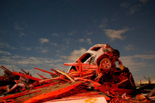 A vehicle sits on a pile of debris from the destruction caused by a tornado that touched down in Washington, Illinois, November 17, 2013. (Photo: Reuters)