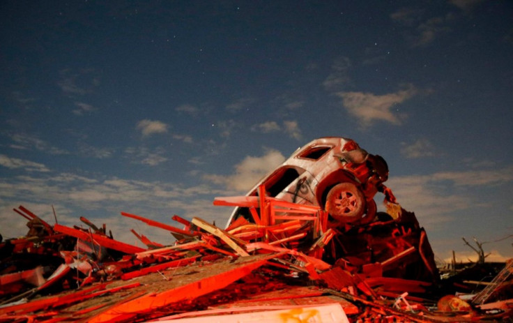 A vehicle sits on a pile of debris from the destruction caused by a tornado that touched down in Washington, Illinois, November 17, 2013. (Photo: Reuters)