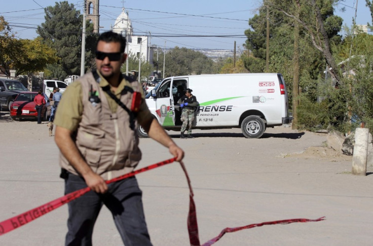 A forensic technician cordons off a crime scene in Ciudad Juarez