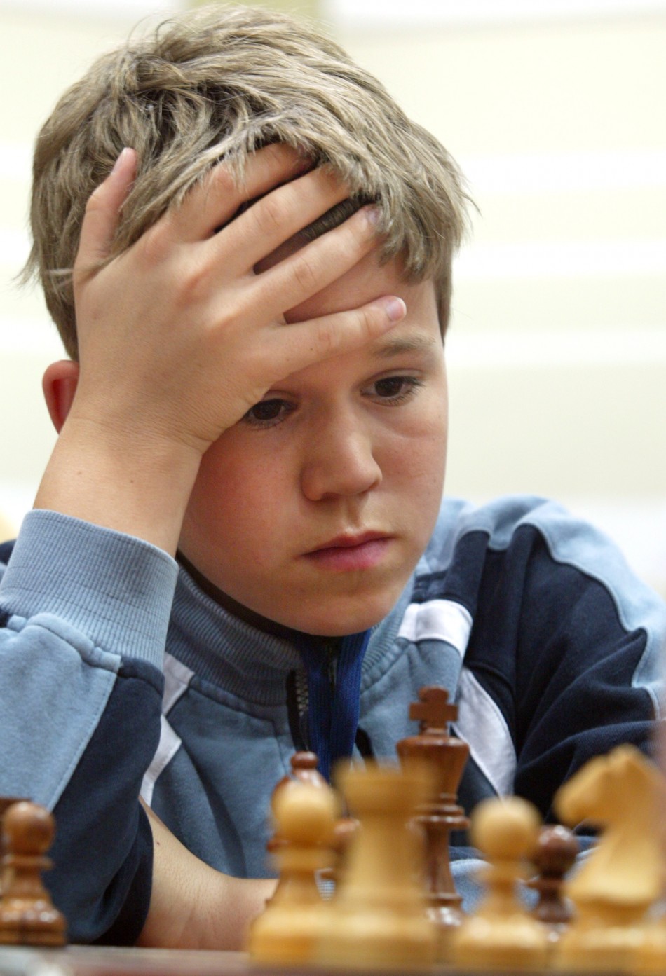 13 year old Norwegian Magnus Carlsen concentrates during a match with Belarus player Alexei Fedorov in the Dubai Open Chess championship in April 2004
