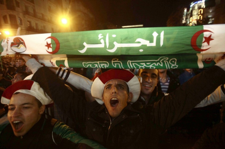 Fans of Algeria's soccer team celebrate in downtown Algiers after their team defeated Burkina Faso in their 2014 World Cup qualifying second leg playoff soccer match